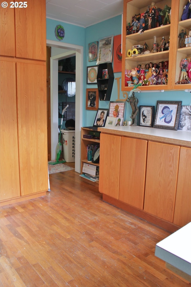 home office with light hardwood / wood-style flooring