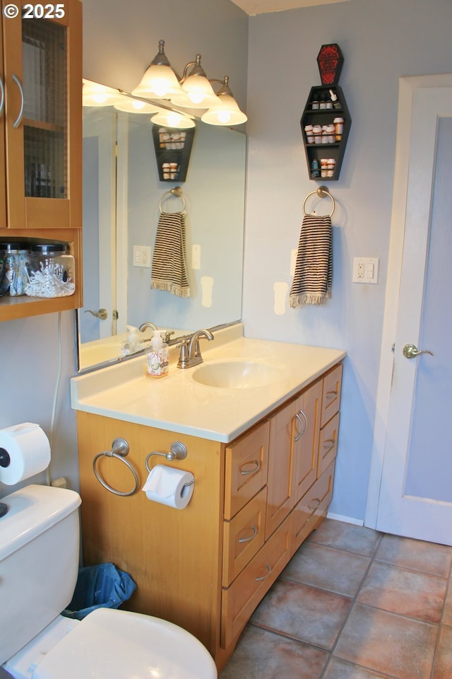 bathroom with vanity, tile patterned flooring, and toilet