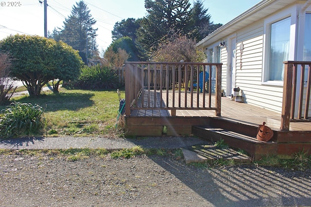 wooden deck with a lawn