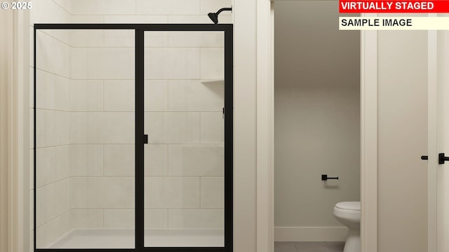 full bathroom with tile patterned floors, toilet, baseboards, and a stall shower