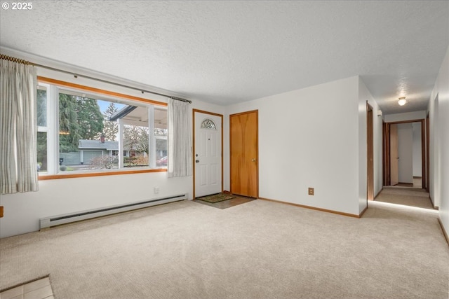 carpeted empty room with a textured ceiling and baseboard heating