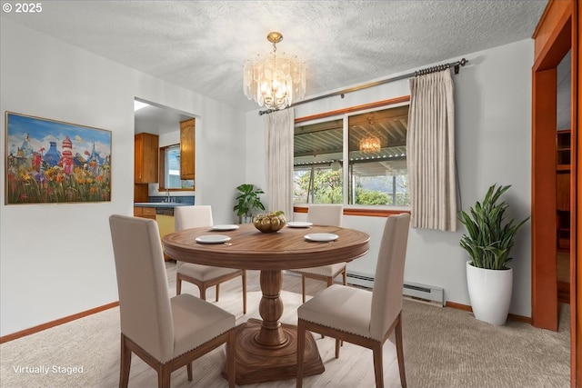 carpeted dining room with a chandelier and a textured ceiling