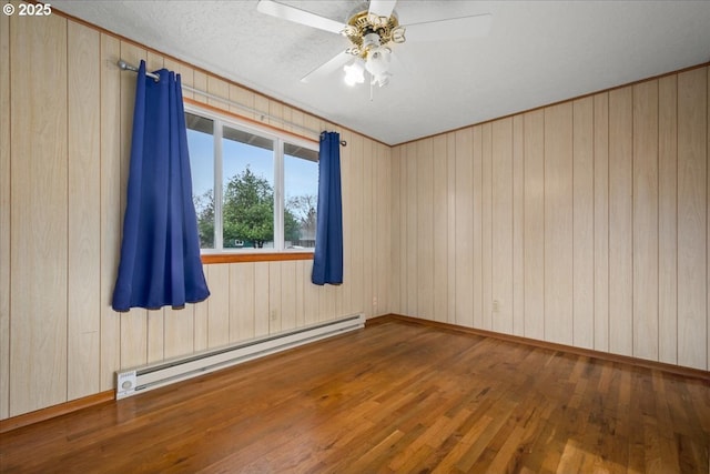 unfurnished room with a baseboard radiator, dark wood-type flooring, a textured ceiling, and ceiling fan