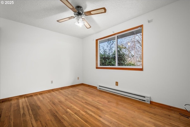 spare room with ceiling fan, hardwood / wood-style floors, a textured ceiling, and baseboard heating