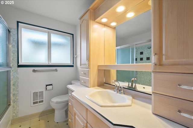 full bathroom with bath / shower combo with glass door, vanity, and toilet