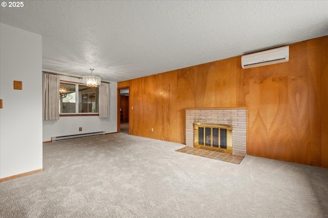 unfurnished living room with a baseboard radiator, a brick fireplace, a wall unit AC, and wood walls