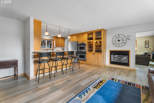 8747 S Heinz Rd, Canby, OR 97013 - living area featuring light wood-style flooring, a multi sided fireplace, and recessed lighting