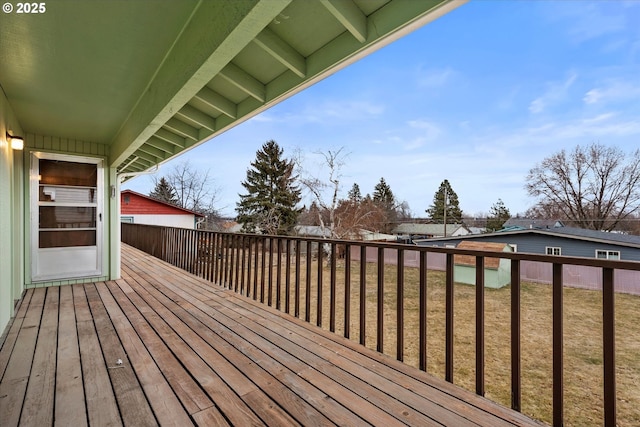 wooden terrace featuring a yard