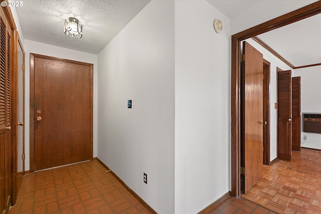 hallway featuring a textured ceiling