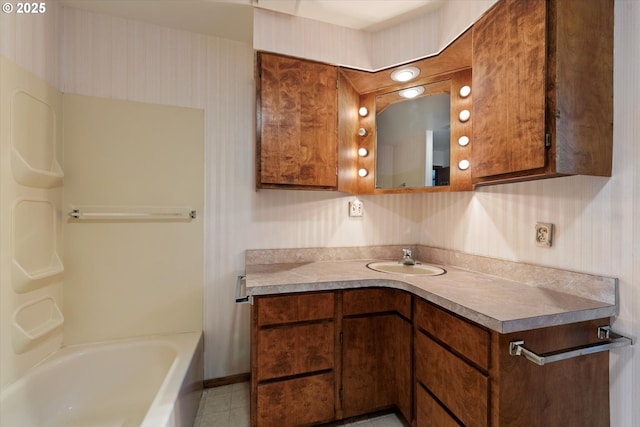 bathroom featuring vanity, a bath, and tile patterned flooring