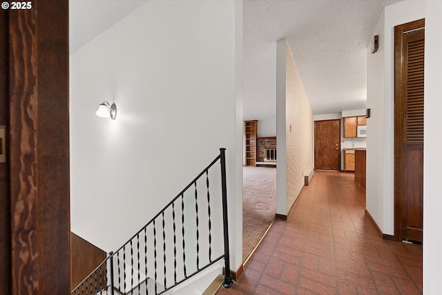 hallway with a textured ceiling