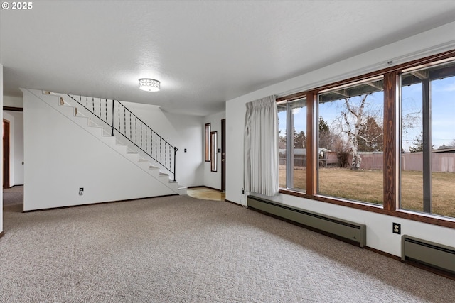 interior space with a baseboard heating unit and carpet flooring