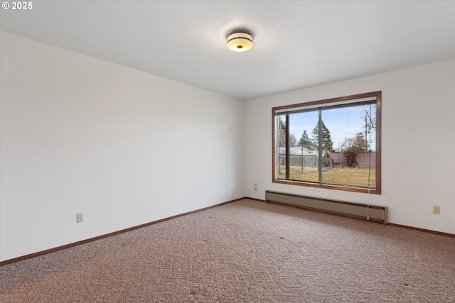 carpeted empty room with a baseboard heating unit