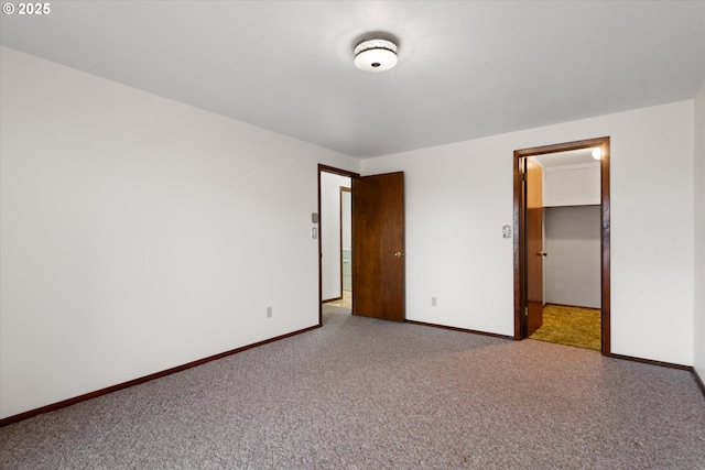 unfurnished bedroom featuring a spacious closet, light colored carpet, and a closet