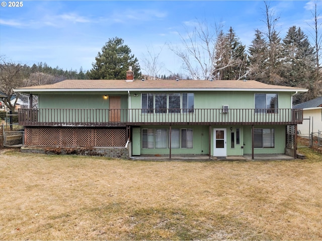 rear view of property featuring a yard