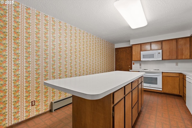 kitchen featuring a center island, a baseboard heating unit, a textured ceiling, and white appliances