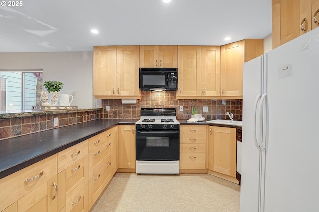2805 NW Upshur St Unit B, Portland, OR 97210 - kitchen featuring freestanding refrigerator, gas range, black microwave, light brown cabinetry, and backsplash