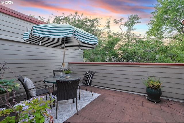 2805 NW Upshur St Unit B, Portland, OR 97210 - patio terrace at dusk featuring a patio and outdoor dining space