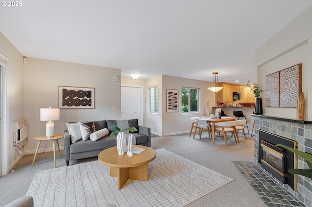 2805 NW Upshur St Unit B, Portland, OR 97210 - living area featuring light colored carpet, heating unit, and a fireplace with flush hearth
