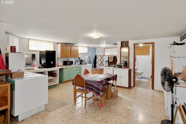 kitchen featuring white cabinets and green cabinets