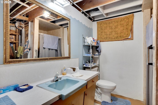 bathroom featuring vanity, toilet, and a shower with shower curtain
