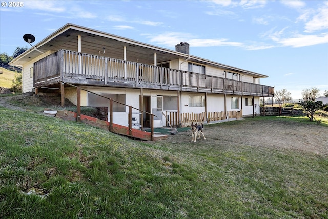 back of property featuring a yard and a deck