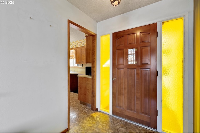 foyer featuring a textured ceiling