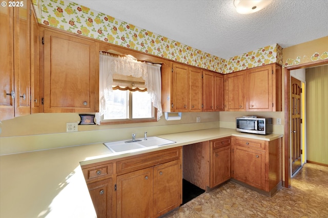 kitchen featuring sink and a textured ceiling