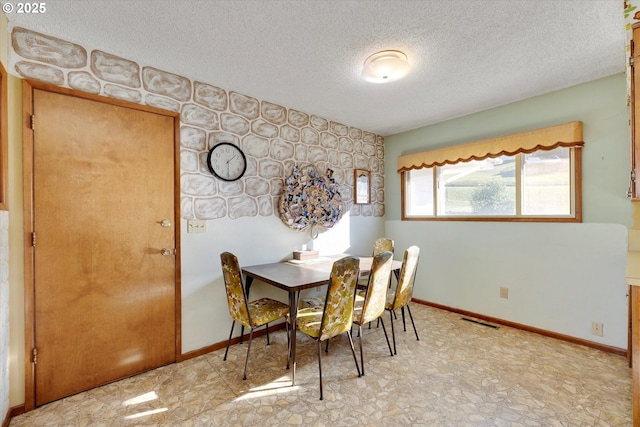 dining room with a textured ceiling