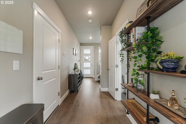 foyer featuring wood finished floors, baseboards, and recessed lighting