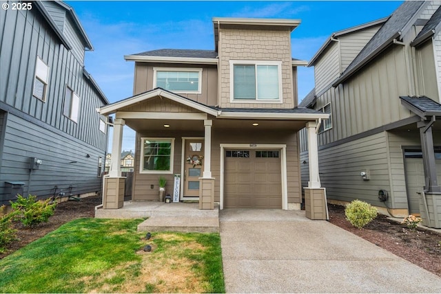 view of front of property featuring an attached garage, concrete driveway, and covered porch