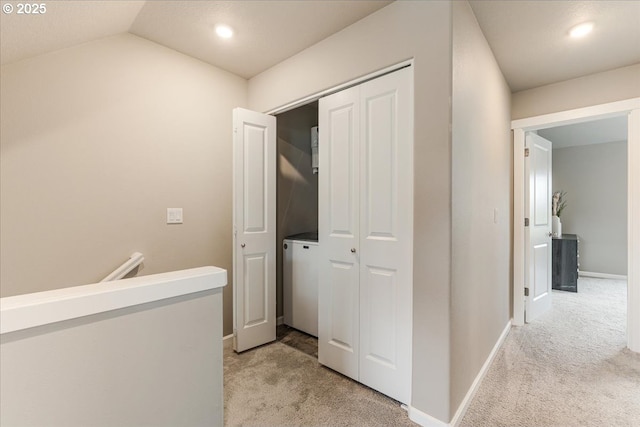 corridor featuring light carpet, baseboards, recessed lighting, washer / clothes dryer, and lofted ceiling