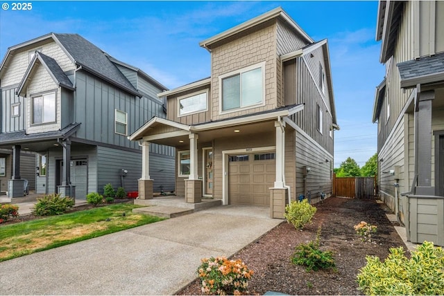 view of front of house featuring board and batten siding, an attached garage, fence, and driveway