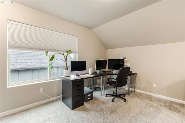 office area with carpet flooring, vaulted ceiling, and baseboards