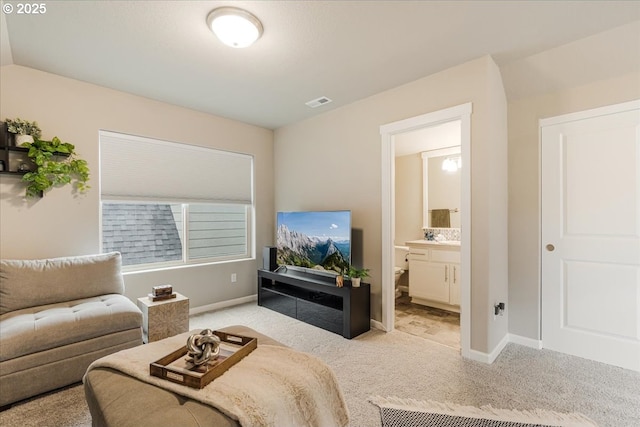 living area featuring light carpet and baseboards
