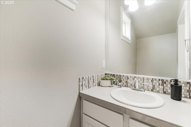bathroom with vanity and decorative backsplash