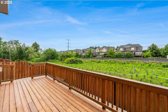 wooden terrace featuring fence and a residential view