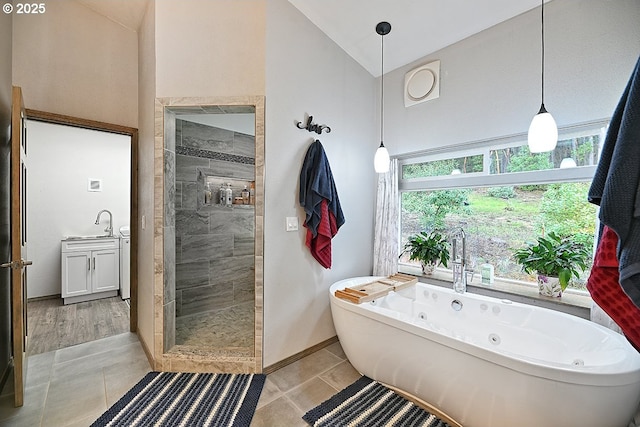 full bath with high vaulted ceiling, a tub with jets, tile patterned floors, a stall shower, and baseboards