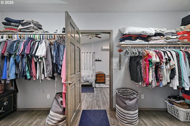 spacious closet with wood finished floors and ceiling fan
