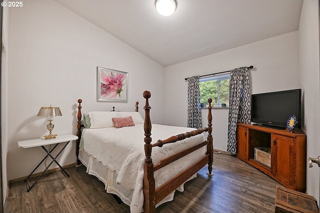 bedroom with vaulted ceiling and dark wood finished floors
