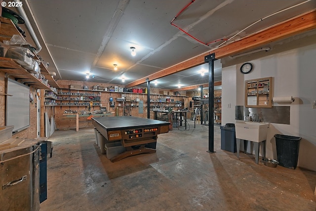 game room with a workshop area and unfinished concrete flooring