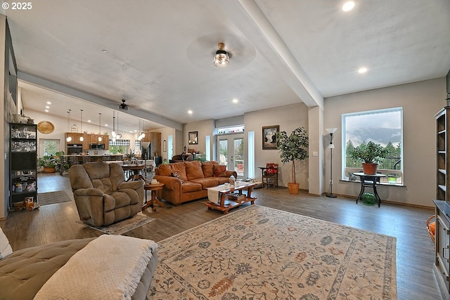 living room featuring vaulted ceiling, ceiling fan, french doors, and dark hardwood / wood-style floors