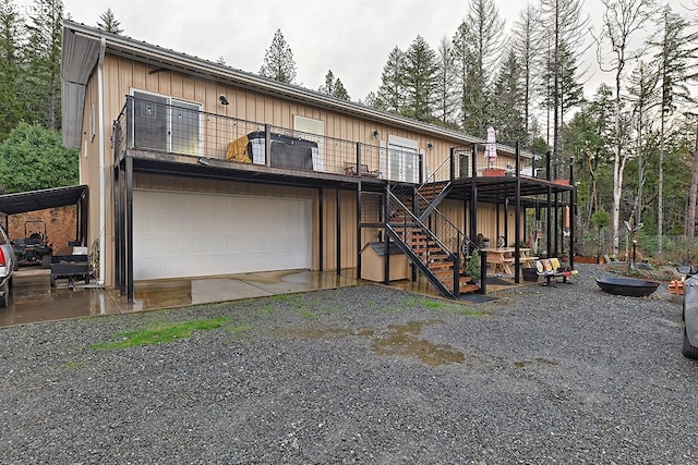 rear view of property featuring a garage