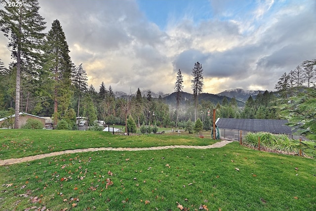 yard at dusk featuring a mountain view