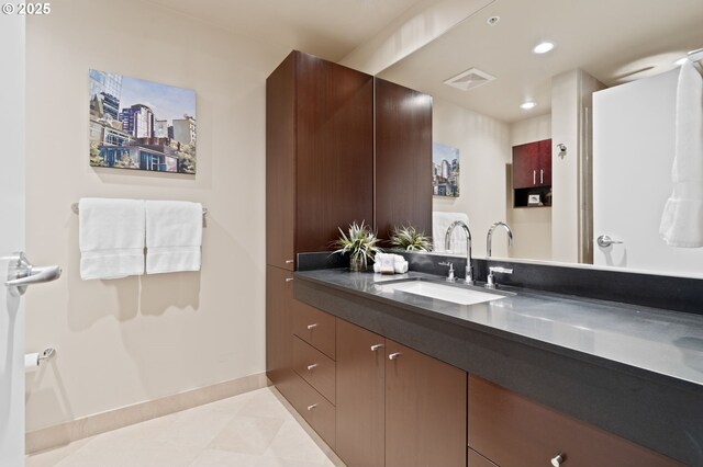 bathroom with baseboards, vanity, tile patterned flooring, and recessed lighting