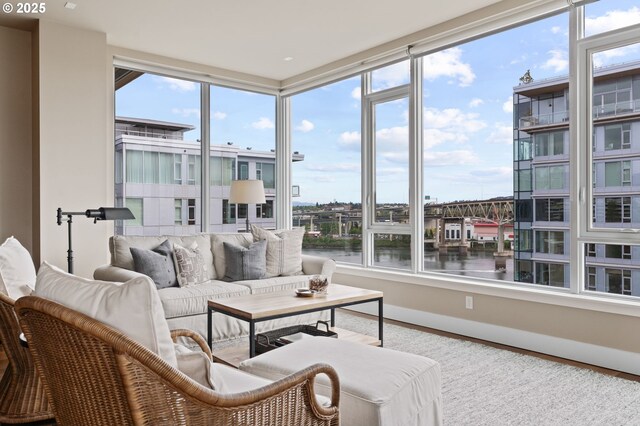 living room with baseboards and a water view