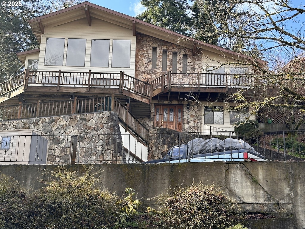 exterior space with stone siding and stairs