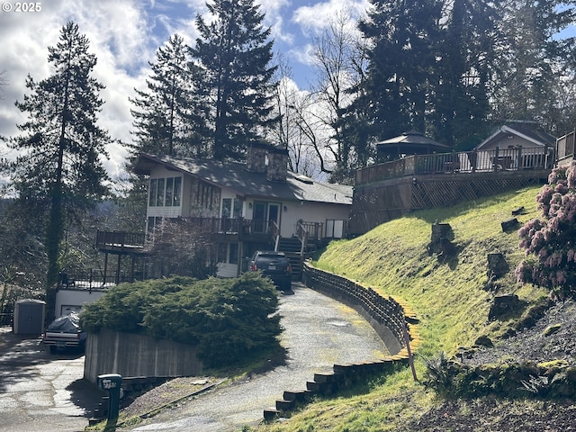 exterior space featuring a chimney and stairs