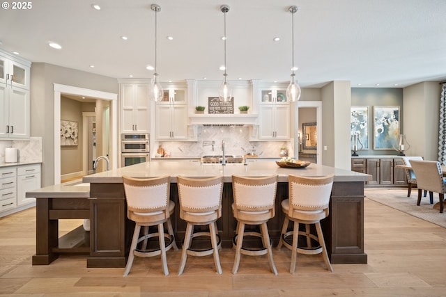 22100 NE 41st Ct, Ridgefield, WA 98642 - kitchen with appliances with stainless steel finishes, light countertops, white cabinetry, light wood-style flooring, and recessed lighting