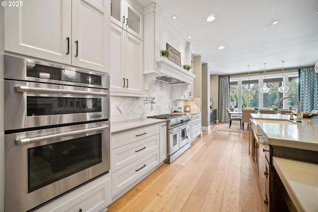 22100 NE 41st Ct, Ridgefield, WA 98642 - kitchen with stainless steel built in refrigerator, white cabinetry, open shelves, decorative backsplash, and recessed lighting